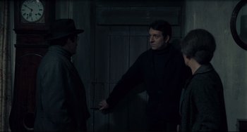 Movie still from “Army of Shadows” (1969), directed by Jean-Pierre Melville – A man in a black jacket and a man in a black hat; Medium shot, Over the shoulder angle