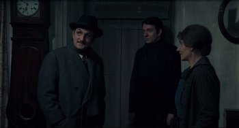 Movie still from “Army of Shadows” (1969), directed by Jean-Pierre Melville – A group of men standing next to each other; Medium shot, Low angle