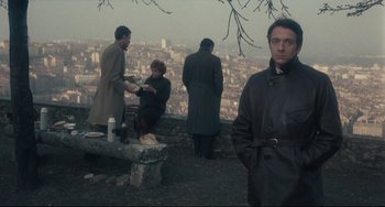 Movie still from “Army of Shadows” (1969), directed by Jean-Pierre Melville – A group of people standing on top of a hill; Medium shot, Over the shoulder angle