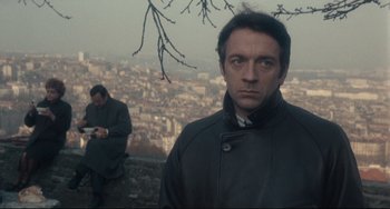 Movie still from “Army of Shadows” (1969), directed by Jean-Pierre Melville – A man standing on top of a hill next to another man; Close Up shot, Low angle