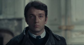 Movie still from “Army of Shadows” (1969), directed by Jean-Pierre Melville – A person wearing a jacket and tie; Close Up shot, Low angle