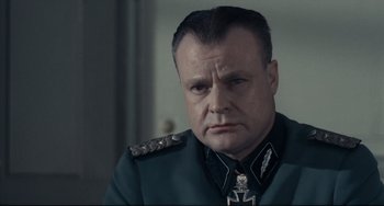 Movie still from “Army of Shadows” (1969), directed by Jean-Pierre Melville – A person wearing a uniform; Close Up shot, Low angle