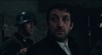 Movie still from “Army of Shadows” (1969), directed by Jean-Pierre Melville – A man in a black jacket and a man in a black suit; Close Up shot, Over the shoulder angle