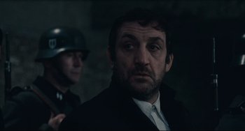 Movie still from “Army of Shadows” (1969), directed by Jean-Pierre Melville – A person wearing a suit and tie; Close Up shot, Over the shoulder angle