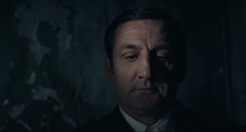 Movie still from “Army of Shadows” (1969), directed by Jean-Pierre Melville – A person wearing a suit and tie; Close Up shot, Low angle