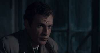 Movie still from “Army of Shadows” (1969), directed by Jean-Pierre Melville – A person wearing a suit and tie; Close Up shot, High angle