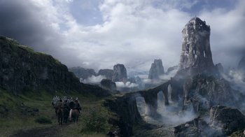 Movie still from “Game of Thrones” (2011), created by D.B. Weiss – A group of people on horseback riding through the mountains; Extreme Wide shot, High angle