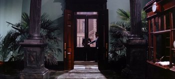 Movie still from “Around the World in 80 Days” (1956), directed by John Farrow – A man standing in front of an open front door; Extreme Wide shot, Low angle