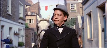 Movie still from “Around the World in 80 Days” (1956), directed by John Farrow – A man in a suit and a hat standing next to a horse; Close Up shot, Low angle