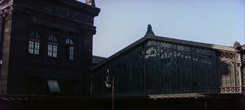 Movie still from “Around the World in 80 Days” (1956), directed by John Farrow – An old building with a clock tower in the background; Extreme Wide shot, Low angle