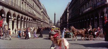 Movie still from “Around the World in 80 Days” (1956), directed by John Farrow – A crowd of people walking down a street near tall buildings; Extreme Wide shot, High angle