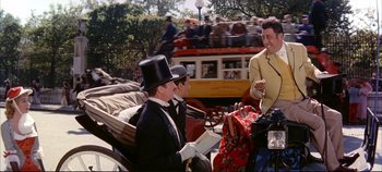 Movie still from “Around the World in 80 Days” (1956), directed by John Farrow – A group of men sitting on top of horse drawn carriages; Medium shot, Over the shoulder angle