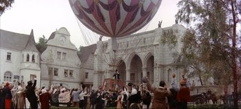 Movie still from “Around the World in 80 Days” (1956), directed by John Farrow – A group of people gathered around a large balloon; Extreme Wide shot, High angle