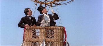 Movie still from “Around the World in 80 Days” (1956), directed by John Farrow – Two men in suits and top hats are in a balloon; Wide shot, Low angle