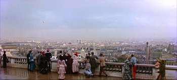 Movie still from “Around the World in 80 Days” (1956), directed by John Farrow – A group of people standing on top of a building; Extreme Wide shot, High angle