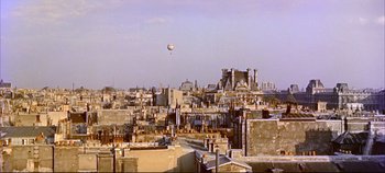 Movie still from “Around the World in 80 Days” (1956), directed by John Farrow – An aerial view of a city with a balloon in the sky; Extreme Wide shot, High angle