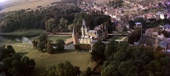 Movie still from “Around the World in 80 Days” (1956), directed by John Farrow – An aerial view of an old castle in the middle of a town; Extreme Wide shot, High angle