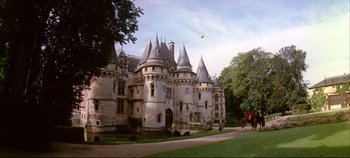 Movie still from “Around the World in 80 Days” (1956), directed by John Farrow – A castle with a person riding a horse in front of it; Extreme Wide shot, High angle