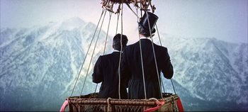 Movie still from “Around the World in 80 Days” (1956), directed by John Farrow – Two men in suits and top hats are in a hot air balloon; Wide shot, Low angle
