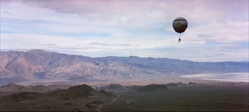 Movie still from “Around the World in 80 Days” (1956), directed by John Farrow – A hot air balloon is flying over a valley; Extreme Wide shot, Low angle