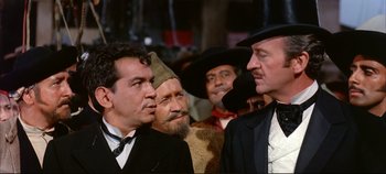 Movie still from “Around the World in 80 Days” (1956), directed by John Farrow – A group of men standing next to each other; Medium shot, Over the shoulder angle