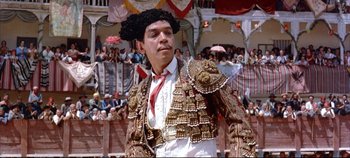 Movie still from “Around the World in 80 Days” (1956), directed by John Farrow – A man in a costume is standing in front of an audience; Medium shot, Low angle