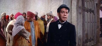 Movie still from “Around the World in 80 Days” (1956), directed by John Farrow – A group of men standing next to each other in a room; Medium shot, Over the shoulder angle