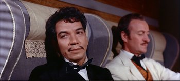 Movie still from “Around the World in 80 Days” (1956), directed by John Farrow – A person wearing a suit and tie; Close Up shot, Low angle
