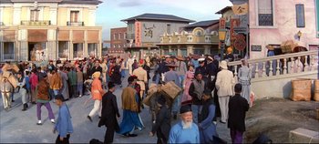 Movie still from “Around the World in 80 Days” (1956), directed by John Farrow – A crowd of people walking down a street; Extreme Wide shot, High angle