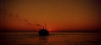 Movie still from “Around the World in 80 Days” (1956), directed by John Farrow – A boat floating on top of a body of water at sunset; Extreme Wide shot, Low angle