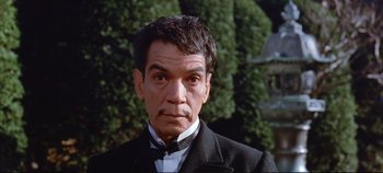 Movie still from “Around the World in 80 Days” (1956), directed by John Farrow – A person wearing a suit and tie; Close Up shot, Low angle