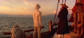Movie still from “Around the World in 80 Days” (1956), directed by John Farrow – Two people standing on a boat in the water; Wide shot, Low angle