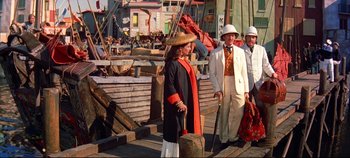 Movie still from “Around the World in 80 Days” (1956), directed by John Farrow – A group of people standing next to each other on a dock; Wide shot, High angle