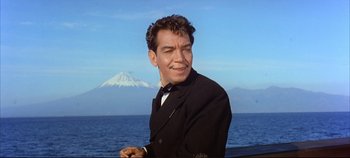 Movie still from “Around the World in 80 Days” (1956), directed by John Farrow – A man wearing a suit and bow tie; Close Up shot, Low angle