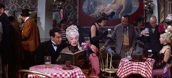 Movie still from “Around the World in 80 Days” (1956), directed by John Farrow – A man and a woman sitting at a table; Medium shot, High angle
