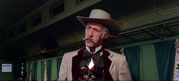 Movie still from “Around the World in 80 Days” (1956), directed by John Farrow – An older man with a mustache wearing a cowboy hat; Close Up shot, Low angle