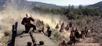 Movie still from “Around the World in 80 Days” (1956), directed by John Farrow – A large group of men on horseback riding across a field; Extreme Wide shot, High angle