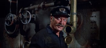Movie still from “Around the World in 80 Days” (1956), directed by John Farrow – A man wearing a black hat and a black shirt; Medium shot, High angle