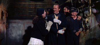 Movie still from “Around the World in 80 Days” (1956), directed by John Farrow – A man and a woman are dressed up and laughing; Medium shot, Over the shoulder angle