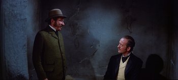 Movie still from “Around the World in 80 Days” (1956), directed by John Farrow – Two men in suits and hats are talking to each other; Medium shot, Over the shoulder angle
