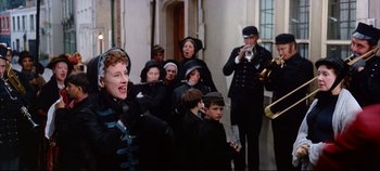 Movie still from “Around the World in 80 Days” (1956), directed by John Farrow – A group of people dressed in black playing music instruments; Medium shot, Low angle