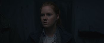 Movie still from “Arrival” (2016), directed by Denis Villeneuve – A woman with red hair is looking at the camera; Close Up shot, Over the shoulder angle