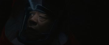 Movie still from “Arrival” (2016), directed by Denis Villeneuve – A man wearing a helmet is looking into the distance; Close Up shot, Low angle