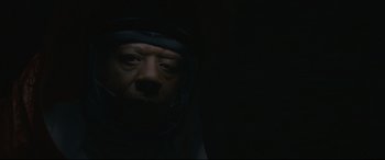 Movie still from “Arrival” (2016), directed by Denis Villeneuve – A man with a helmet on looking at the camera; Close Up shot, Low angle