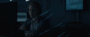Movie still from “Arrival” (2016), directed by Denis Villeneuve – A person with headphones sitting in a room; Medium shot, Over the shoulder angle