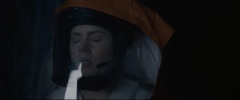 Movie still from “Arrival” (2016), directed by Denis Villeneuve – A woman wearing a helmet is looking into the distance; Close Up shot, Overhead angle