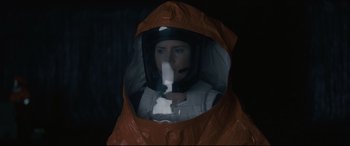 Movie still from “Arrival” (2016), directed by Denis Villeneuve – A person in a space suit in a space suit; Medium shot, Overhead angle