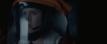Movie still from “Arrival” (2016), directed by Denis Villeneuve – A man wearing a helmet in the dark; Close Up shot, Low angle