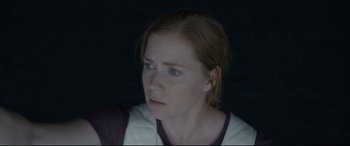 Movie still from “Arrival” (2016), directed by Denis Villeneuve – A person wearing a white shirt; Close Up shot, Over the shoulder angle