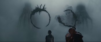 Movie still from “Arrival” (2016), directed by Denis Villeneuve – A group of people standing in front of a smoke filled room; Medium shot, Over the shoulder angle